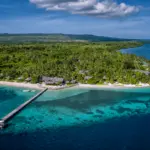 Tropical island with overwater bungalows and pier