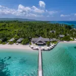 Tropical island resort with overwater bungalows and clear blue waters