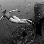 Deep-sea diver exploring underwater wreckage