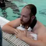 Swimmer Receiving Support in Pool