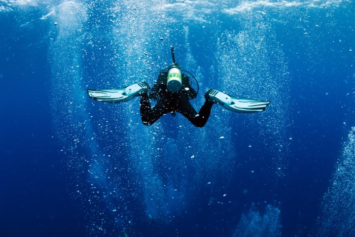 Nitrox diver swims in air bubbles as in whirlpool