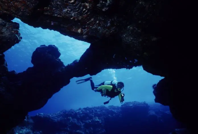 Scuba Diver Exploring a Cavern