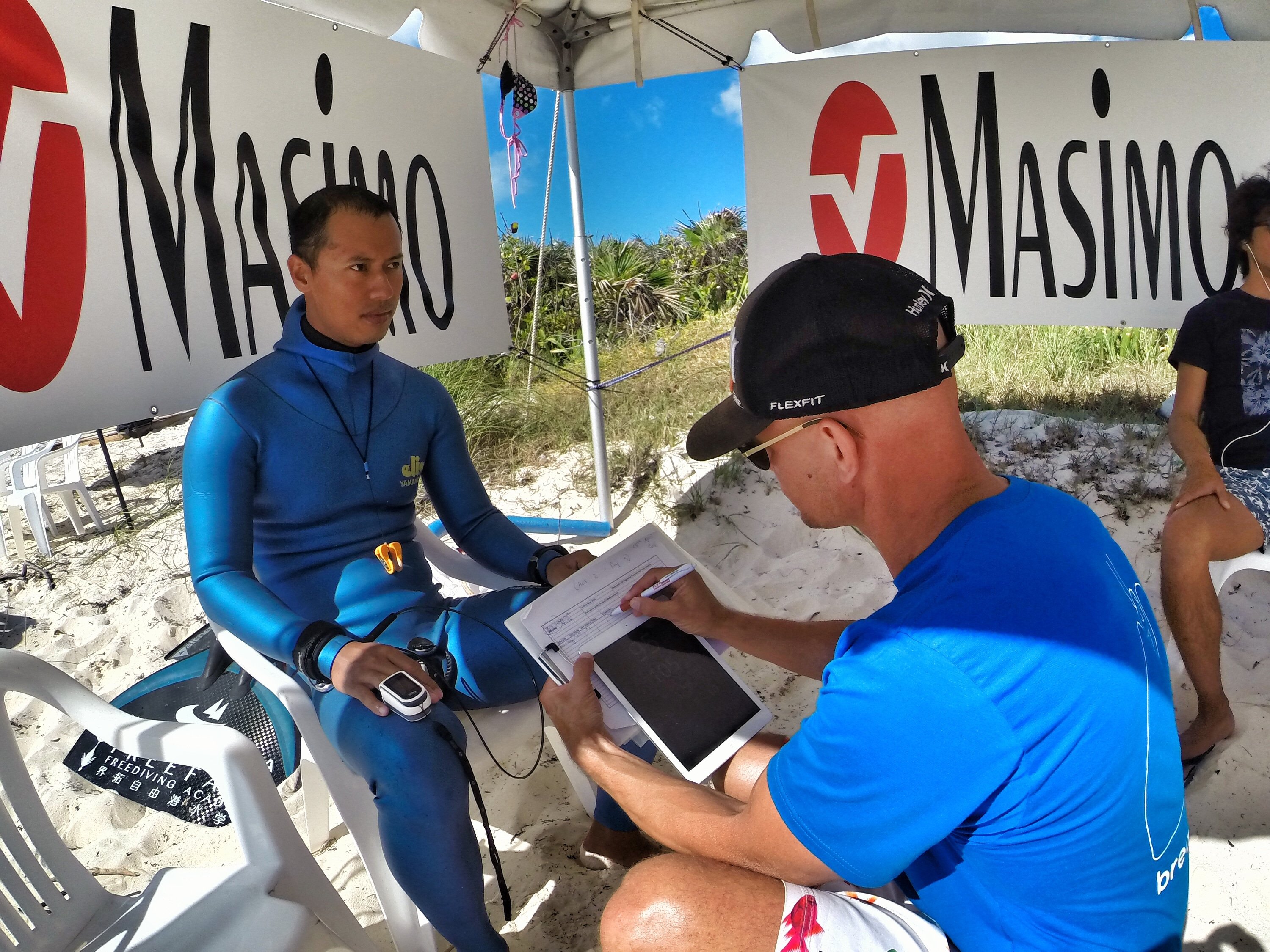 Aolin Wang of China checks in with Dr. Stig after a target depth performance to, have his oxygen levels assessed.
