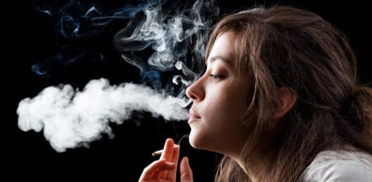 Woman Smoking a Cigarette on Black Background
