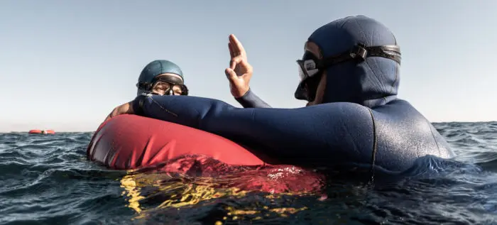 Freediver buddies on surface giving OK signal
