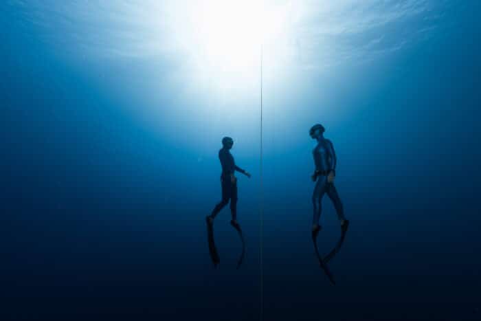 Freediver diving under the guidance of an instructor.