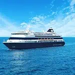 Luxury cruise ship sailing on the ocean under a blue sky