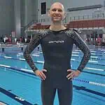 Swimmer in a wetsuit at an indoor pool