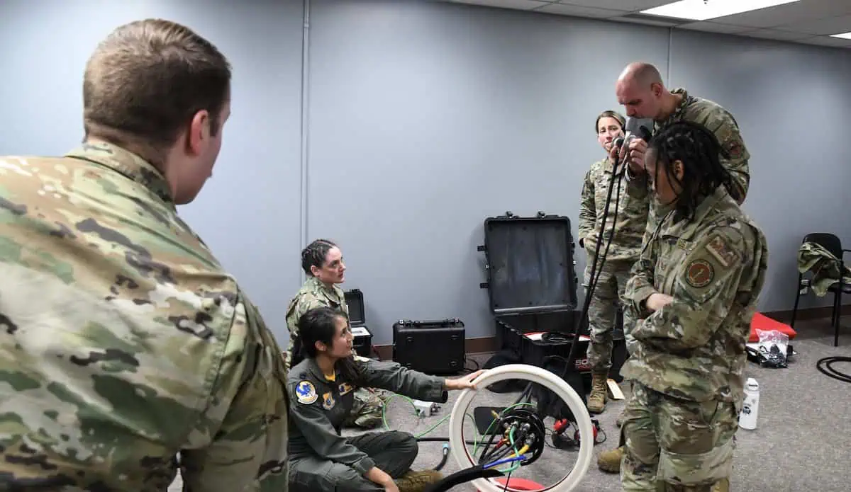 Airmen of the 354th Medical Group set up a portable decompression sickness chamber during a training exercise simulating an emergency for a patient requiring oxygen therapy, utilizing the hyperbaric stretcher both in place and on board the 168th Wing KC-135, May 3, 2024. (Photo by Senior Master Sgt. Julie Avey)